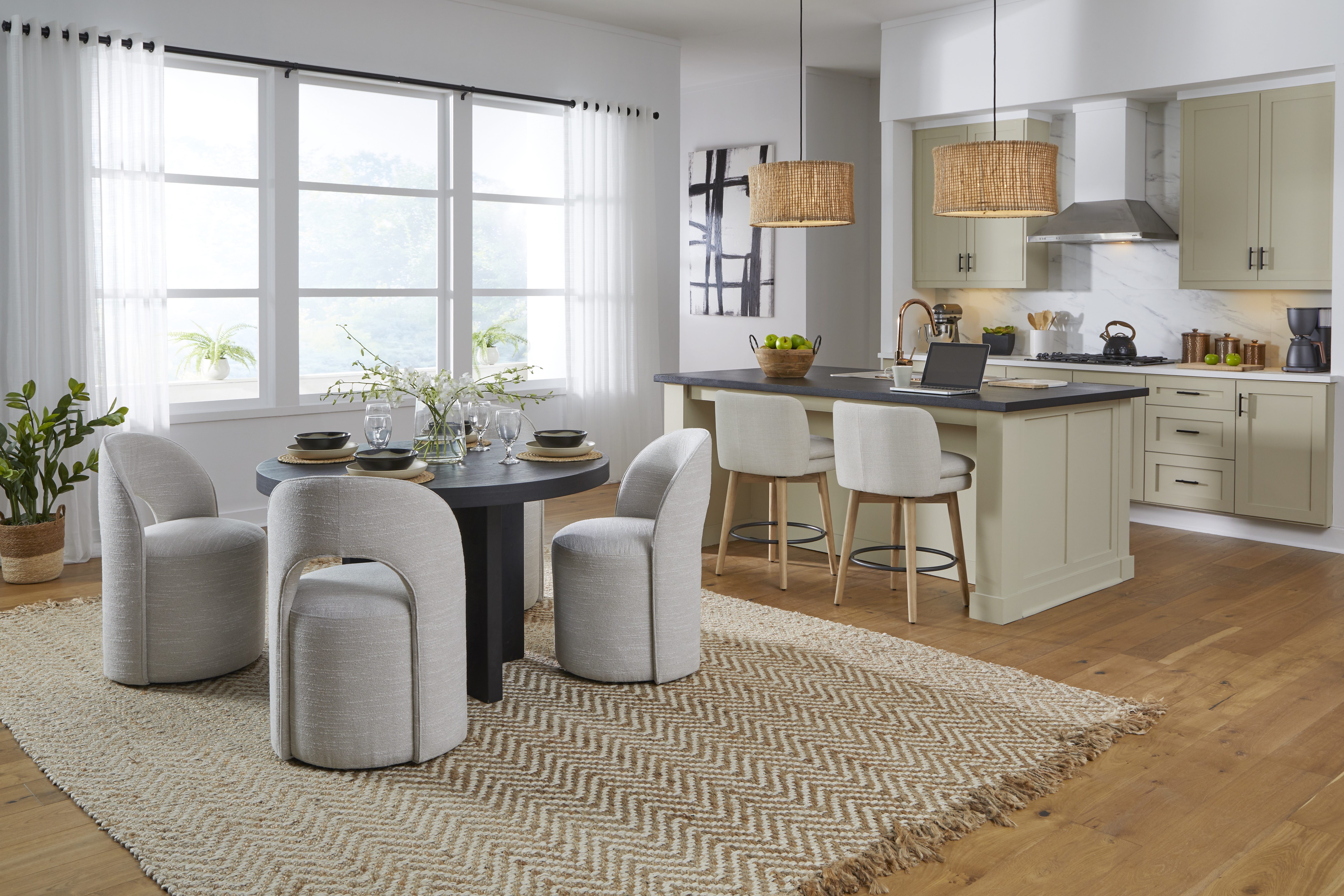 Kuka Home Furnishings kitchen and dining room with light grey upholstered dining chairs and barstools