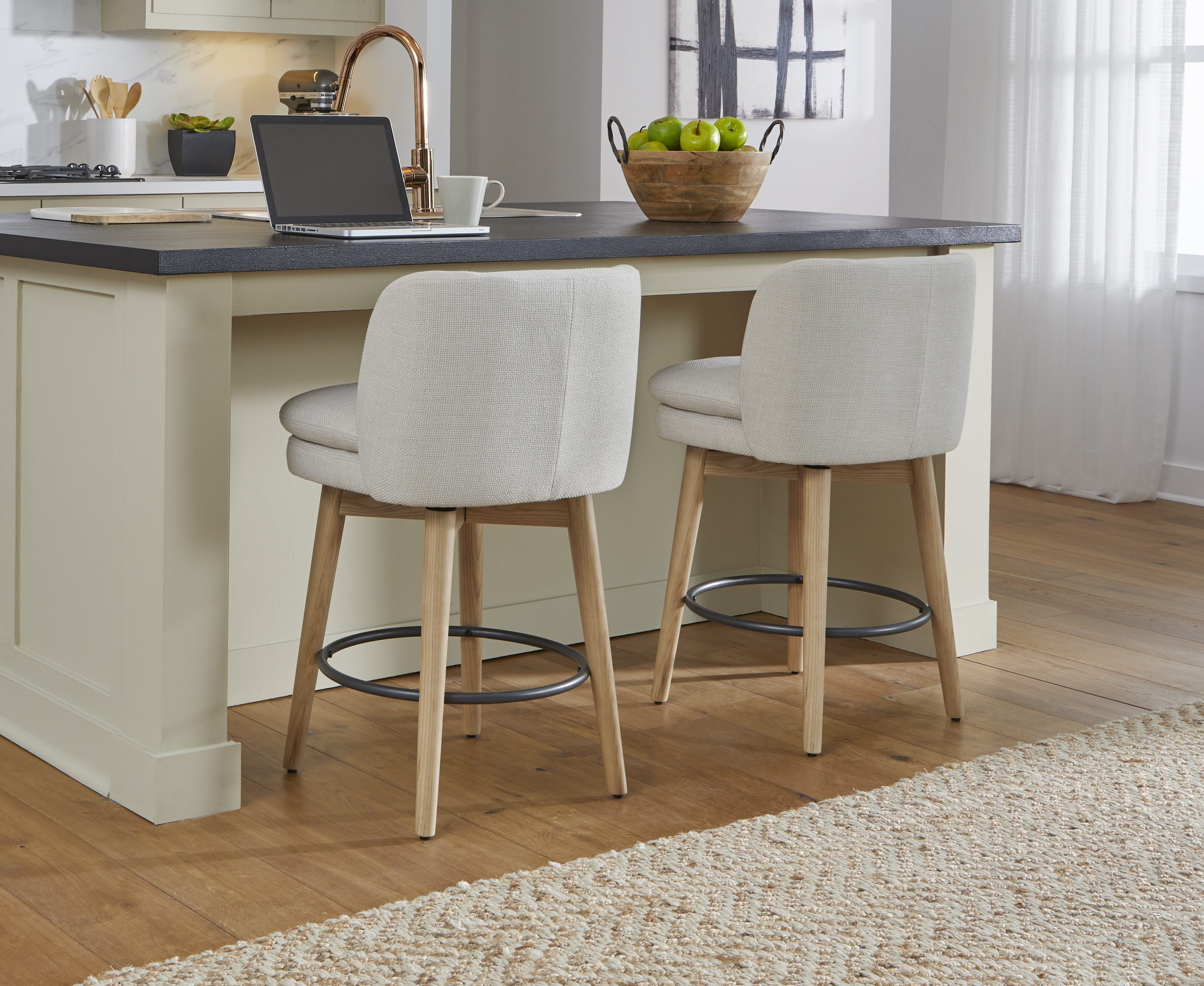 light grey upholstered barstools with wooden legs