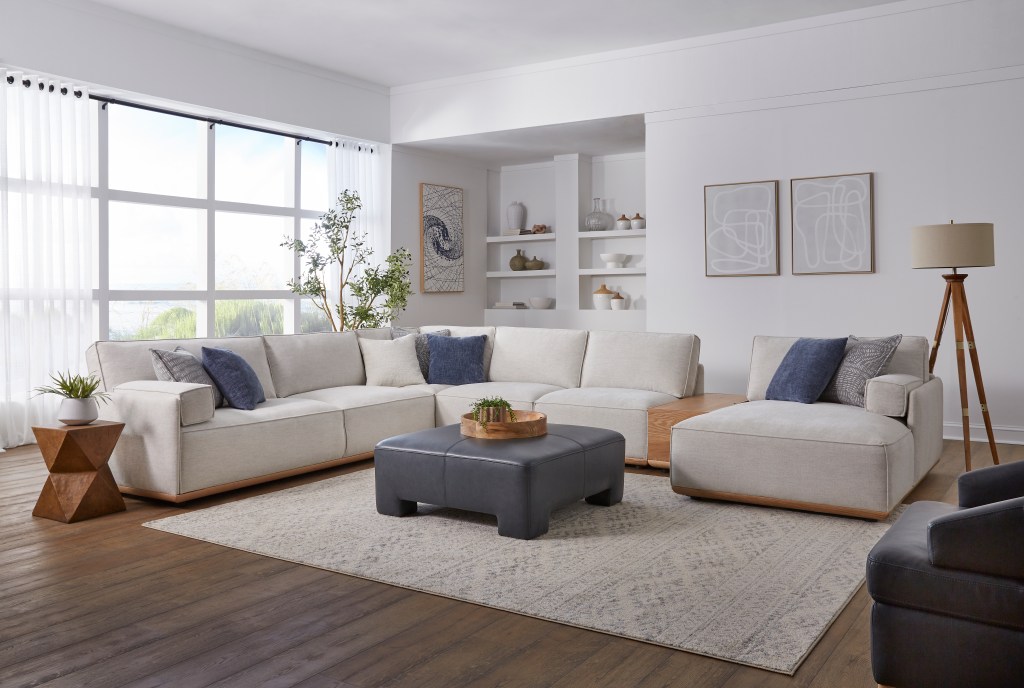 Kuka Home Furnishing's Casual style with cream upholstered sectional with dark leather ottoman 