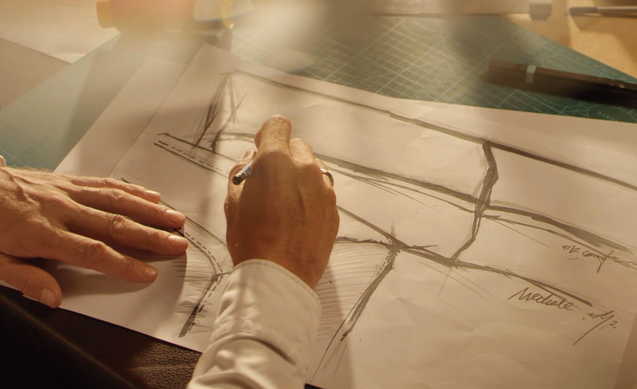 man writing on plans