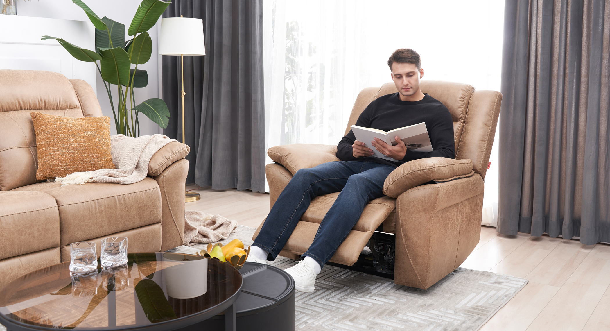 man in recliner reading