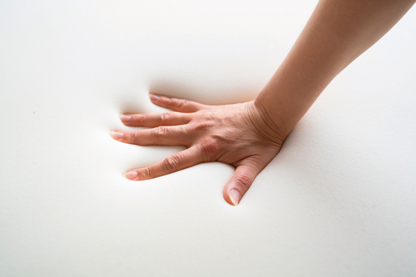 Hand Pressing Down on Foam